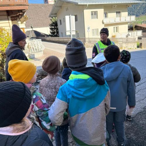 Kinder mit Polizistin auf der Straße beim Üben